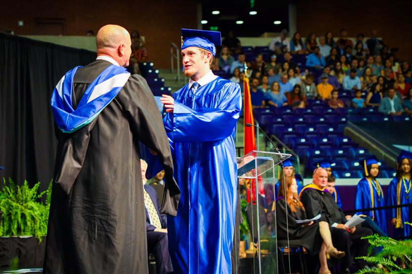A group of graduates wearing blue robes